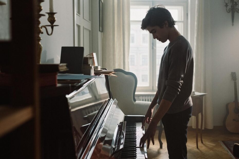 A sad man playing piano